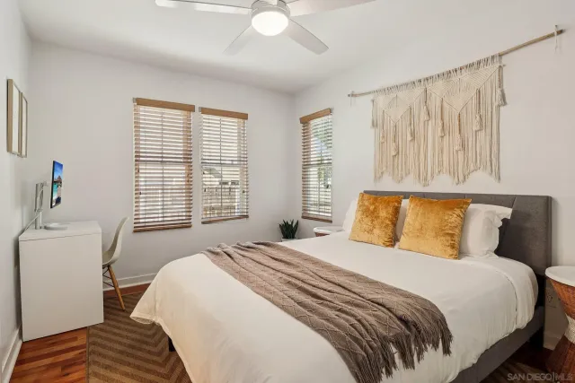 a living room with furniture a refrigerator and kitchen view