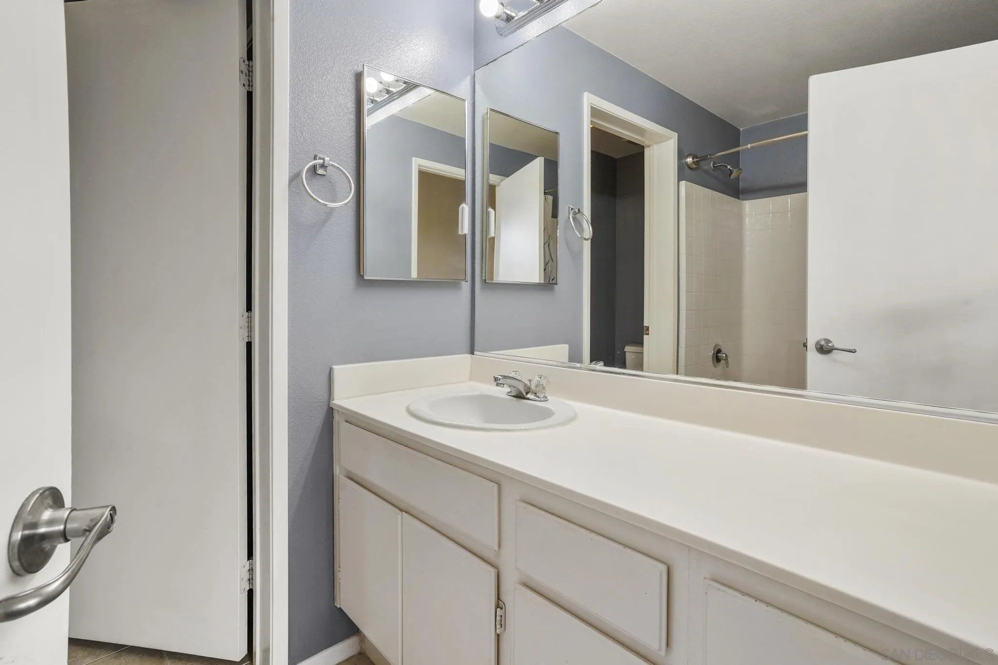 1853 Rue Bienville Place, Unit 833 Chula Vista, CA 91913 - Photo 14 of 23 a bathroom with a sink and a mirror