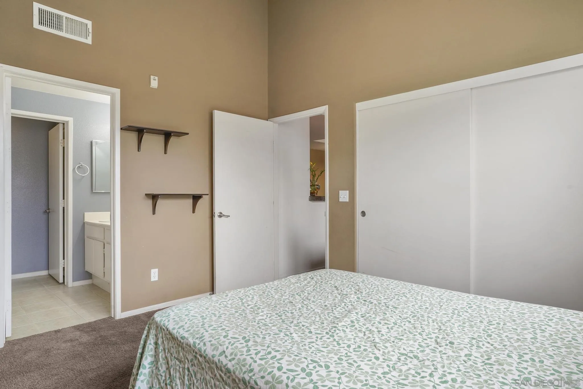 1853 Rue Bienville Place, Unit 833 Chula Vista, CA 91913 - Photo 16 of 23 a bedroom with a bed and a refrigerator