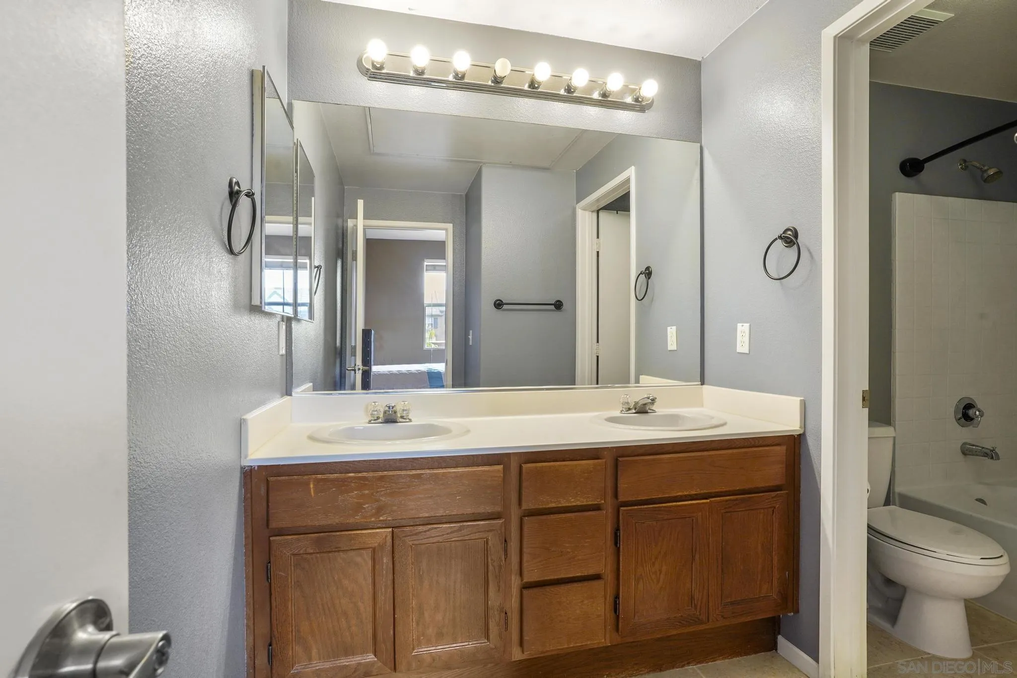 1853 Rue Bienville Place, Unit 833 Chula Vista, CA 91913 - Photo 18 of 23 a bathroom with a sink double vanity and a mirror