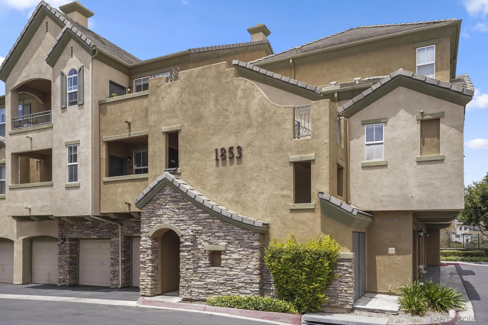 1853 Rue Bienville Place, Unit 833 Chula Vista, CA 91913 - Photo 22 of 23 a front view of a house with a garden