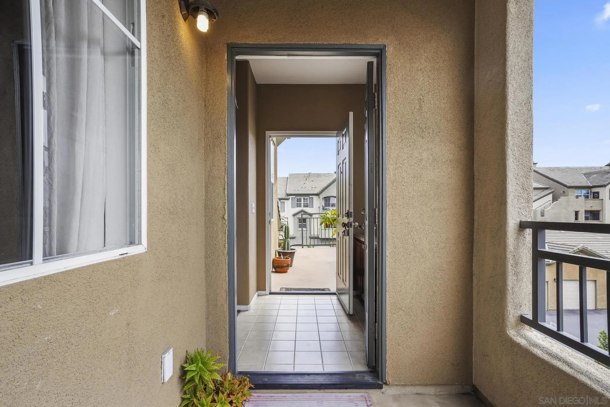 1853 Rue Bienville Place, Unit 833 Chula Vista, CA 91913 - Photo 4 of 23 a view of a hallway with wooden floor and a living room