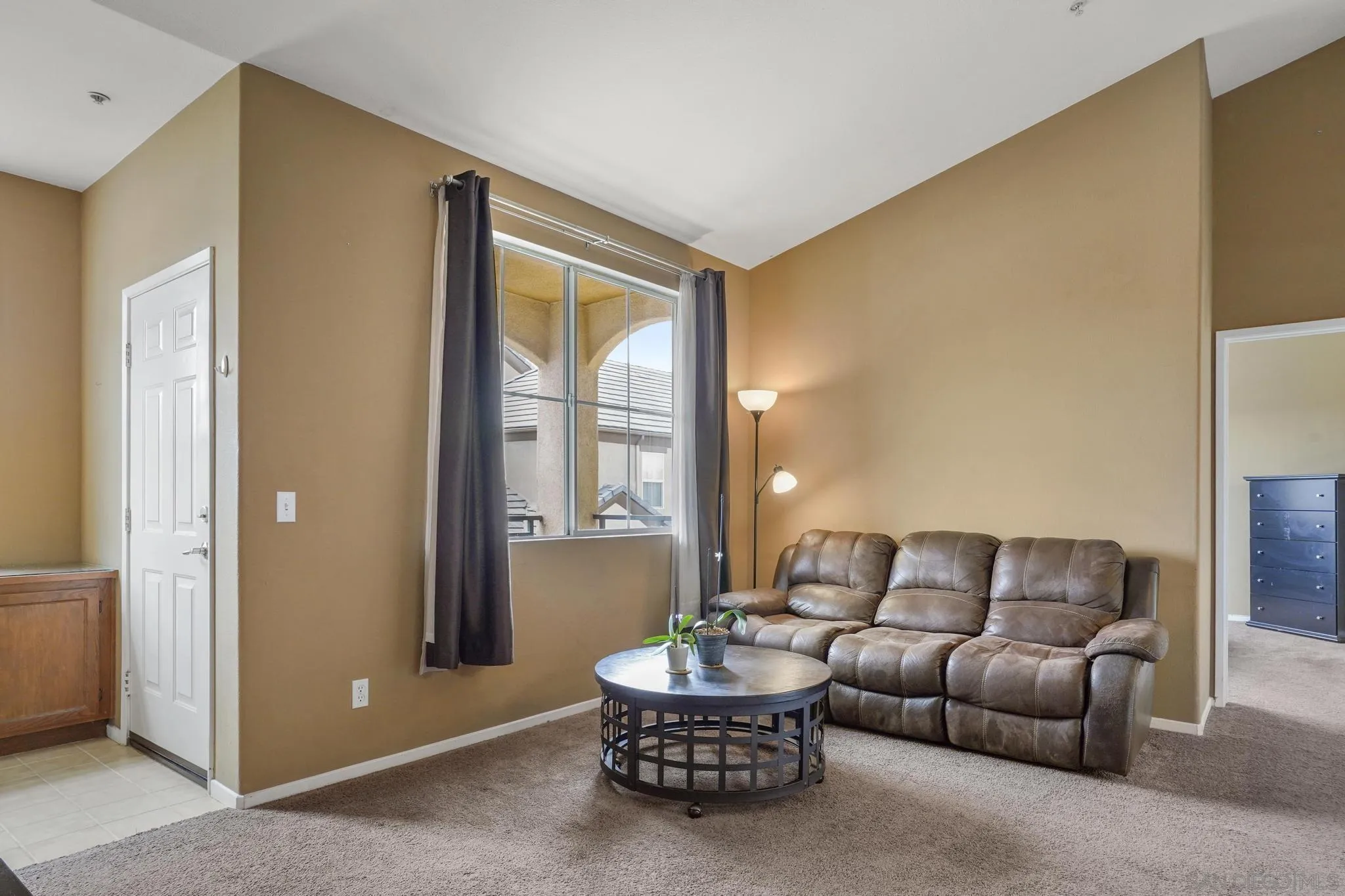 1853 Rue Bienville Place, Unit 833 Chula Vista, CA 91913 - Photo 6 of 23 a living room with furniture and a window