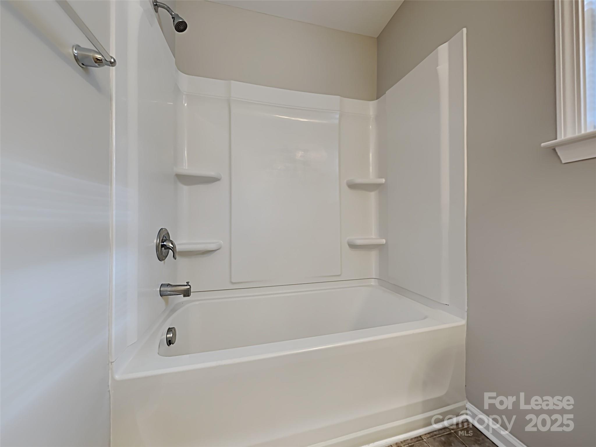 8188 Thornton Street Locust, NC 28097 - Photo 14 of 17 a white bath tub sitting next to a window