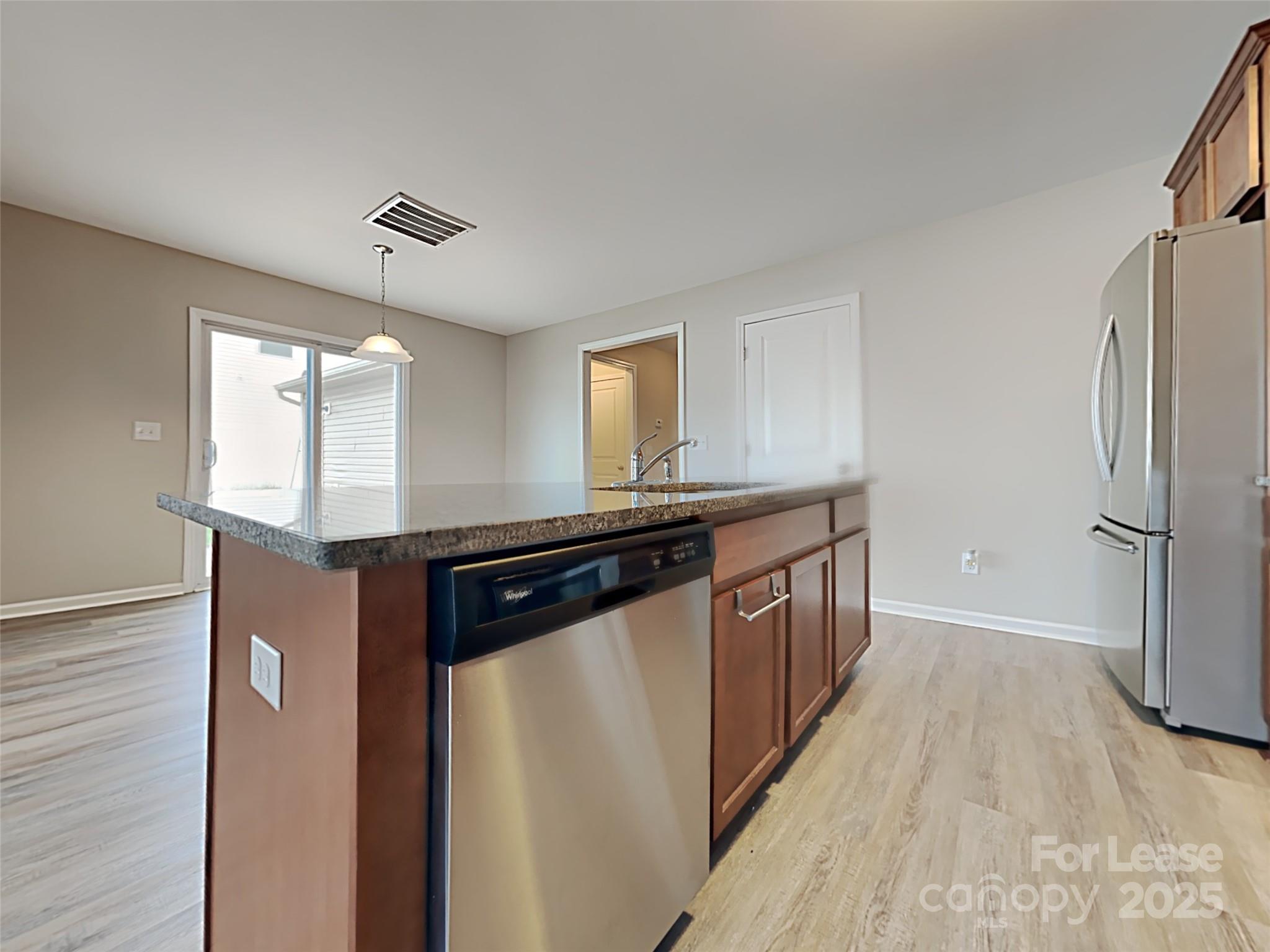 8188 Thornton Street Locust, NC 28097 - Photo 4 of 17 a kitchen with stainless steel appliances granite countertop a refrigerator and a sink