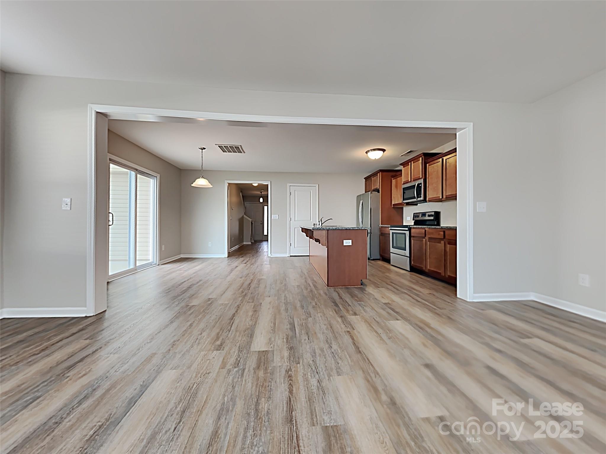 8188 Thornton Street Locust, NC 28097 - Photo 6 of 17 a view of empty room with wooden floor