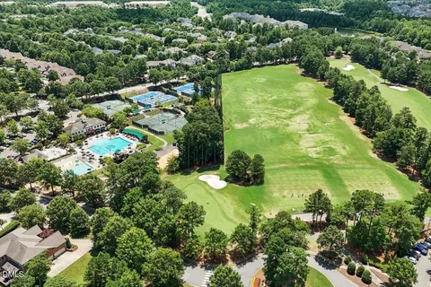 an aerial view of a house with a swimming pool