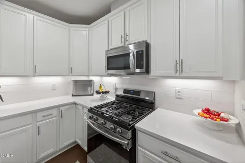 a kitchen with a sink cabinets and wooden floor