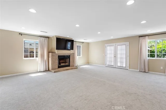 a view of a livingroom with an empty space and a fireplace