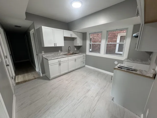 a kitchen with stainless steel appliances a stove a sink and a refrigerator
