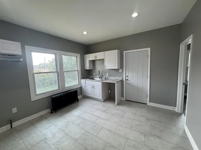 a kitchen with a refrigerator and a sink