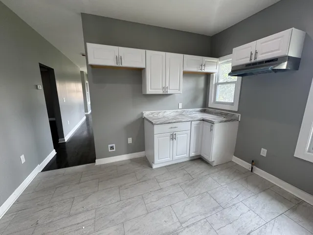 a kitchen with stainless steel appliances granite countertop a refrigerator sink and cabinets
