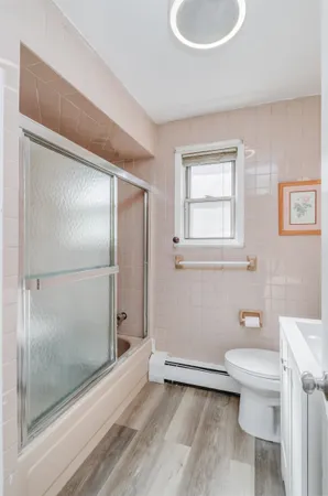 a bathroom with a granite countertop toilet and a shower