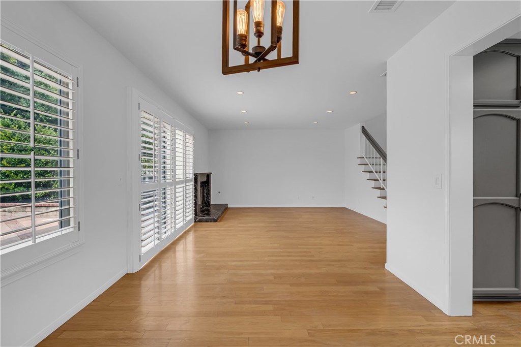 19451 Eagle Ridge Lane Porter Ranch, CA 91326 - Photo 21 of 59 a view of an empty room with wooden floor and a window