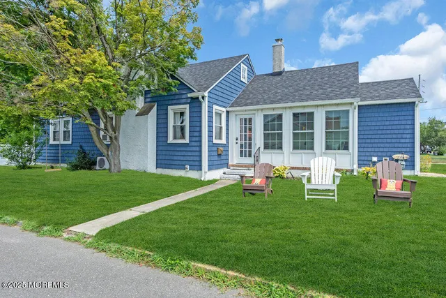 a view of a house with a yard porch and sitting area
