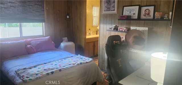 a bedroom with a bed and a painting on the wall