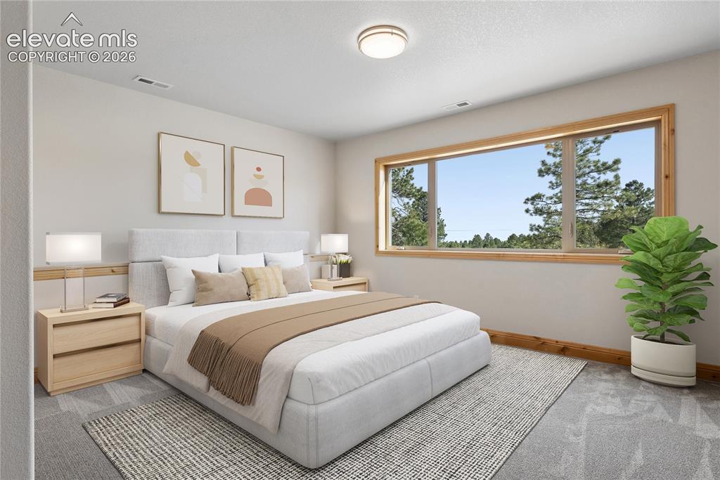 10840 Vollmer Road Colorado Springs, CO 80908 - Photo 37 of 49 a bedroom with a large bed and a painting on the wall