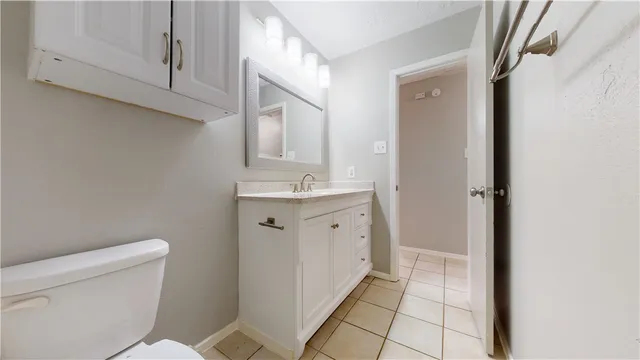 a bathroom with a sink a toilet and a mirror