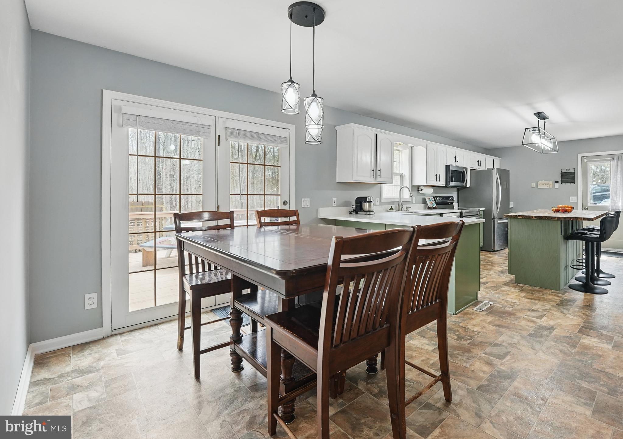 17307 Corder Road Elkwood, VA 22718 - Photo 11 of 20 a kitchen with a dining table chairs and refrigerator