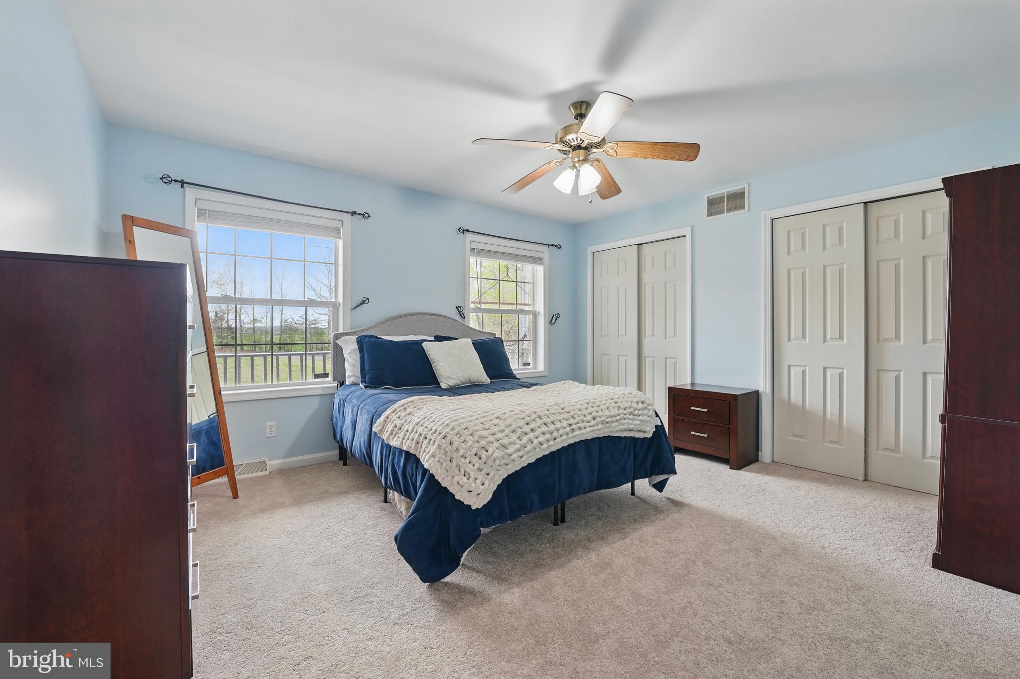 17307 Corder Road Elkwood, VA 22718 - Photo 16 of 20 a bedroom with a bed and a chandelier