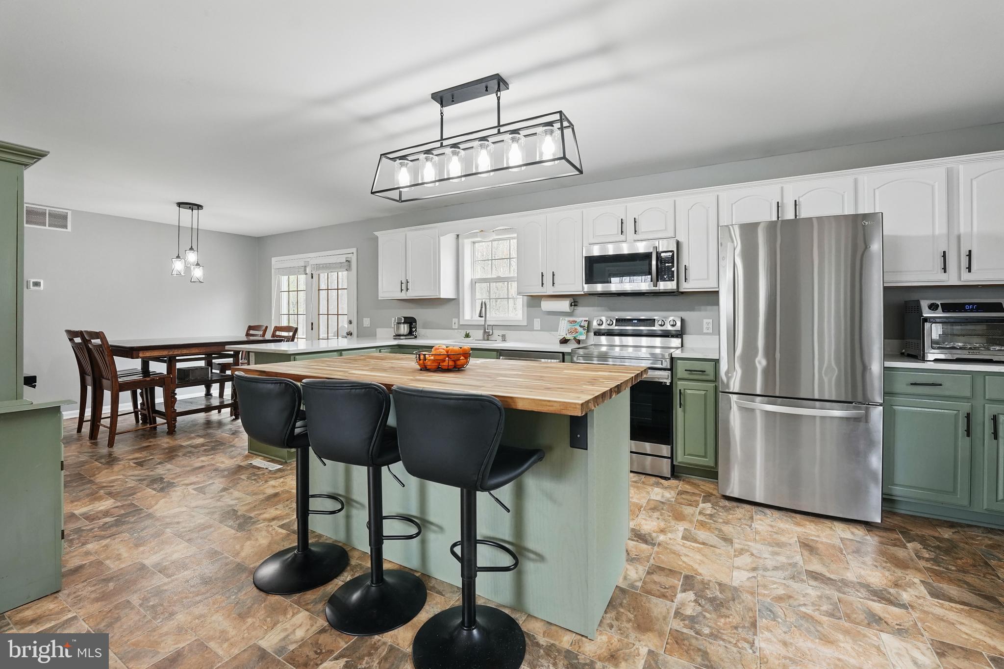 17307 Corder Road Elkwood, VA 22718 - Photo 3 of 20 a kitchen with stainless steel appliances a table chairs refrigerator and a sink
