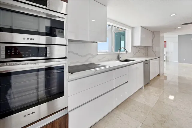 a kitchen with stainless steel appliances a refrigerator and a sink