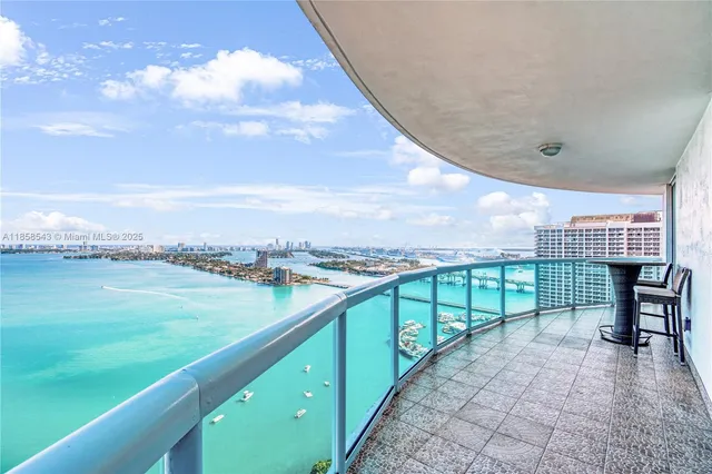 a view of an empty room with cabinet and windows