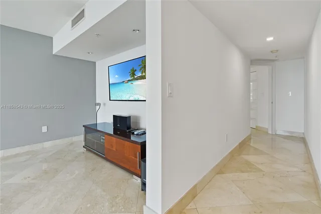 a view of a kitchen with refrigerator and a stove