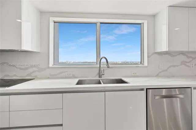 a kitchen with stainless steel appliances granite countertop a stove and a microwave