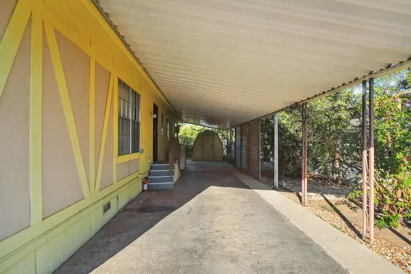 a front view of a house with garden and parking space