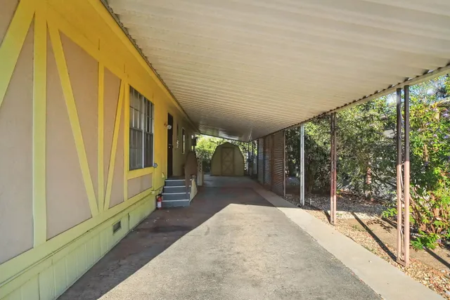 a front view of a house with garden and parking space