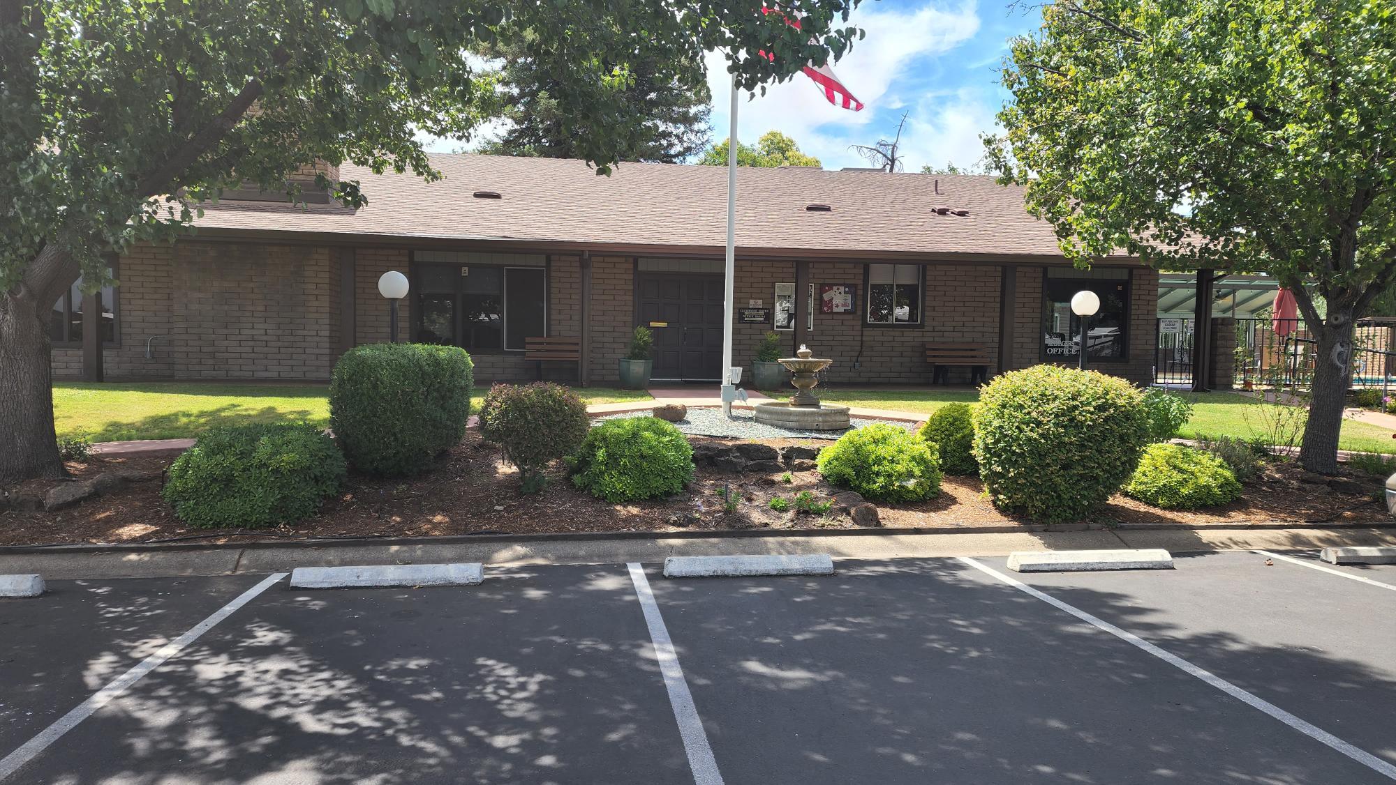 Undisclosed Address Redding, CA 96002 - Photo 30 of 34 a front view of a house with garden and parking space