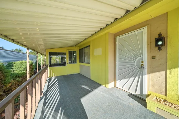 a view of balcony with wooden floor