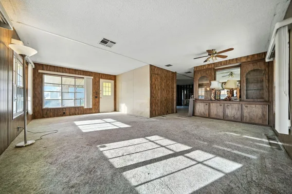 a view of a hallway with a livingroom view