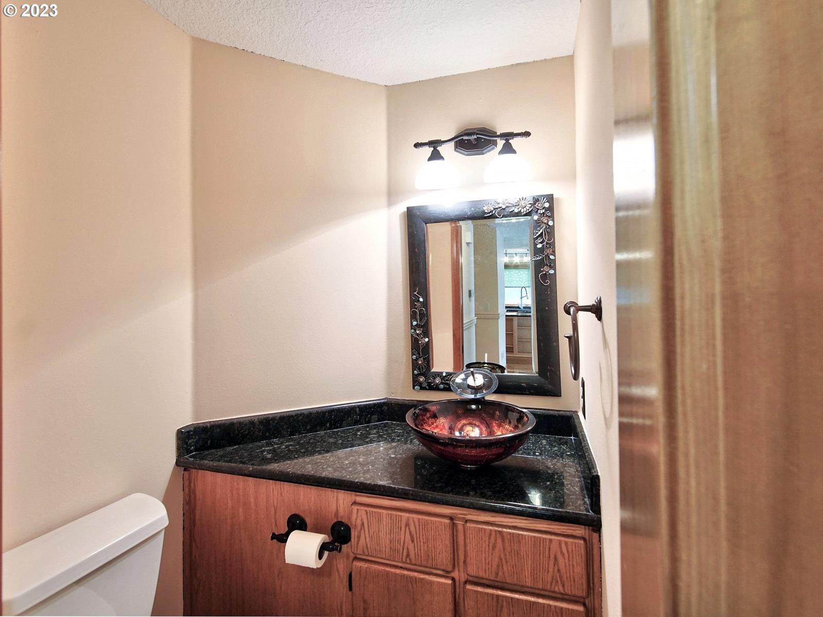 34385 Northeast Sunset Loop Scappoose, OR 97056 - Photo 15 of 42 a bathroom with a granite countertop sink and a mirror