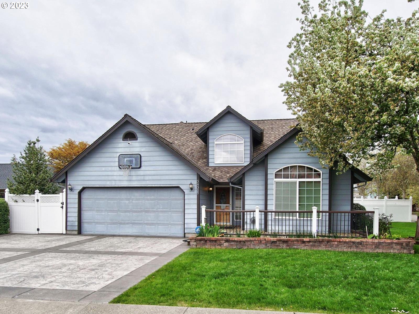 34385 Northeast Sunset Loop Scappoose, OR 97056 - Photo 2 of 42 a front view of a house with a yard and garage