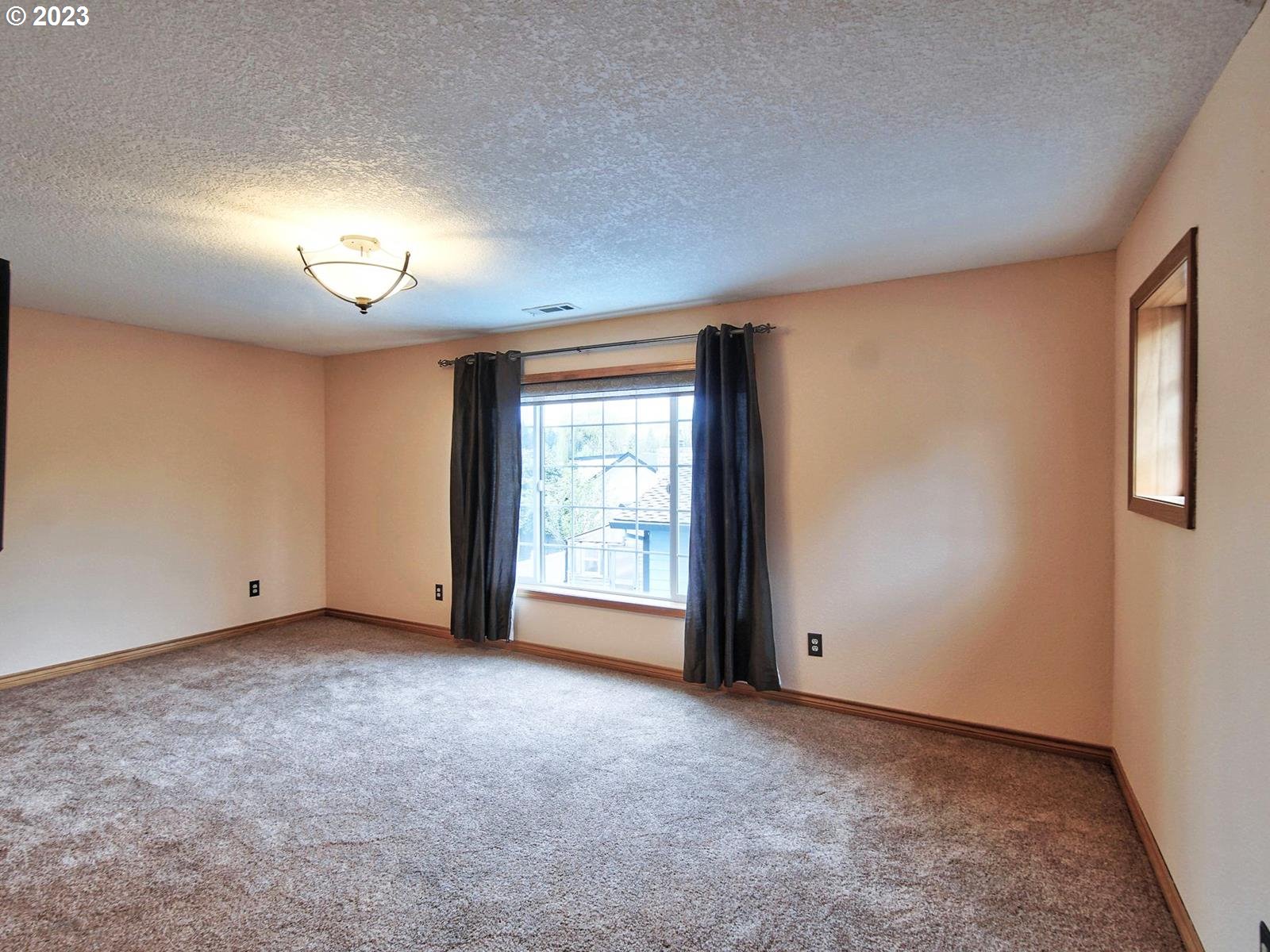 34385 Northeast Sunset Loop Scappoose, OR 97056 - Photo 23 of 42 an empty room with a empty space and a window