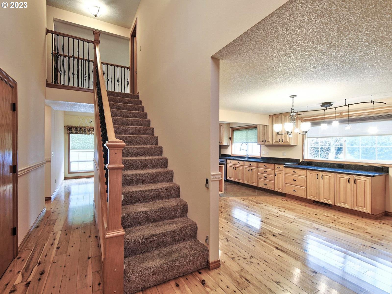 34385 Northeast Sunset Loop Scappoose, OR 97056 - Photo 4 of 42 a view of a kitchen with furniture and stairs