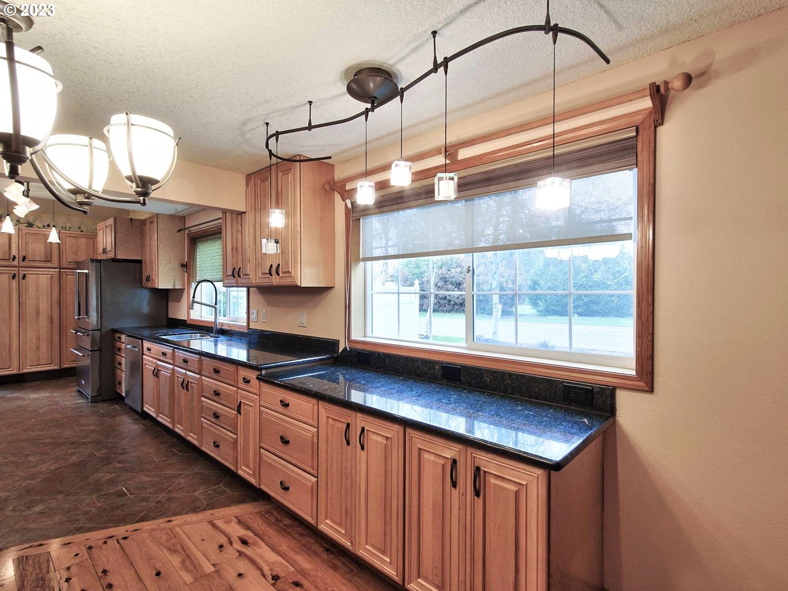 34385 Northeast Sunset Loop Scappoose, OR 97056 - Photo 8 of 42 a kitchen with stainless steel appliances granite countertop a stove a sink and a refrigerator