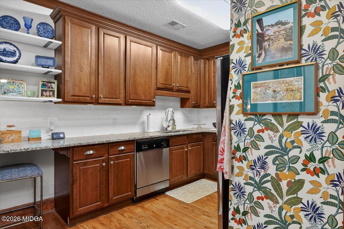 175 Corbin Avenue Macon, GA 31204 - Photo 11 of 21 a kitchen with stainless steel appliances granite countertop a sink and wooden cabinets
