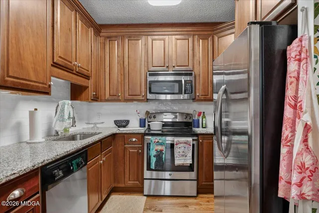 a kitchen with a refrigerator and cabinets