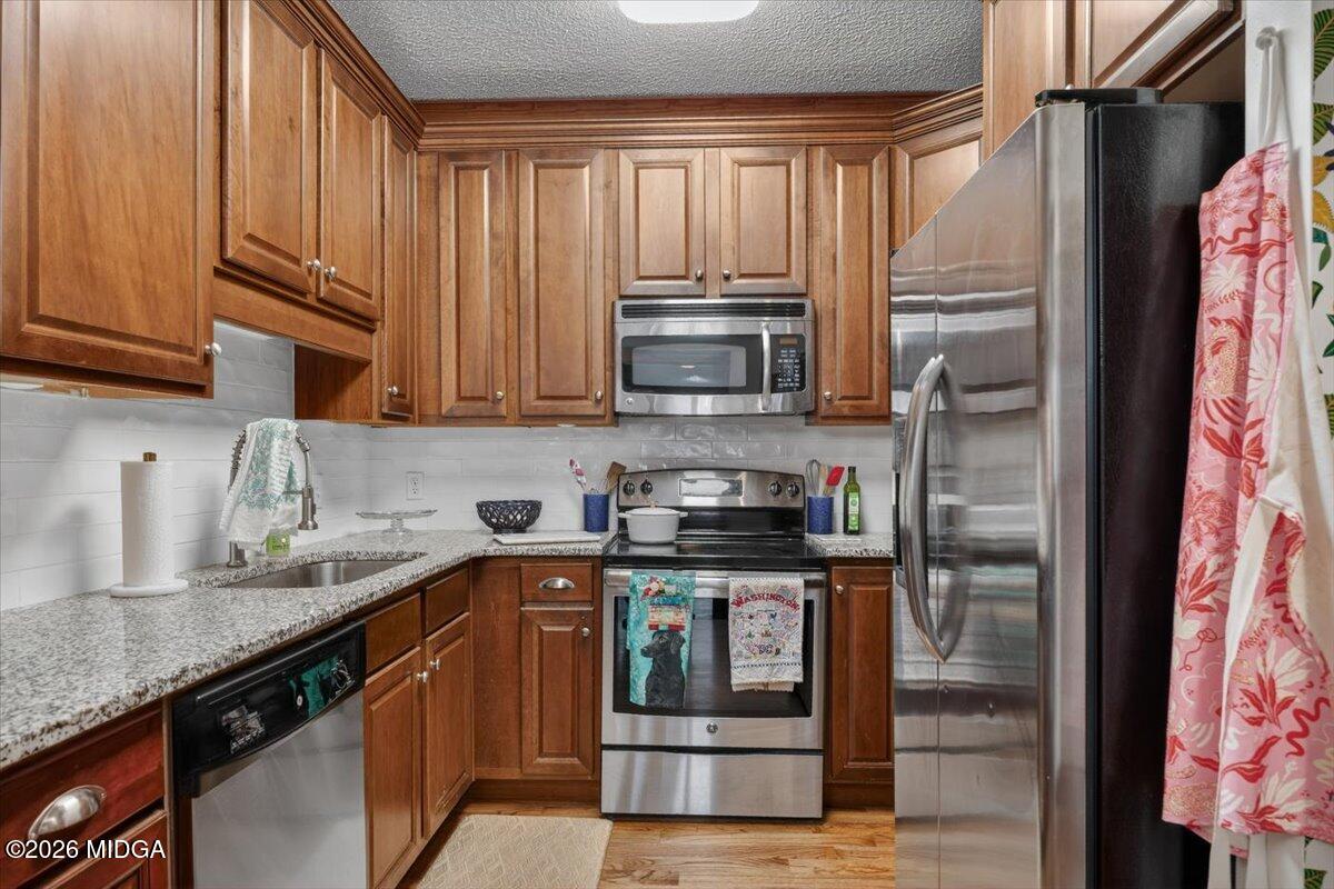 175 Corbin Avenue Macon, GA 31204 - Photo 12 of 21 a kitchen with stainless steel appliances granite countertop a refrigerator a sink and a stove