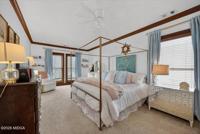 a bedroom with a bed flat screen tv and a couch