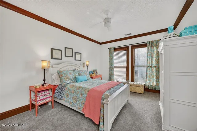 a bedroom with a bed and a table