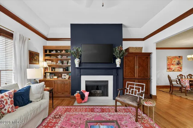 a living room with furniture a fireplace and a table