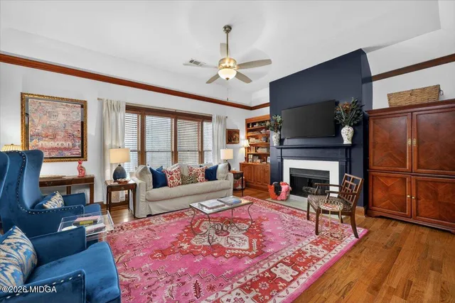 a view of a dining room with furniture a chandelier and wooden floor