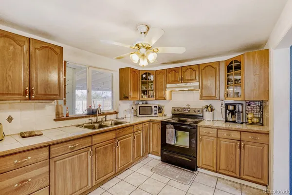 a kitchen with a sink stove and cabinets