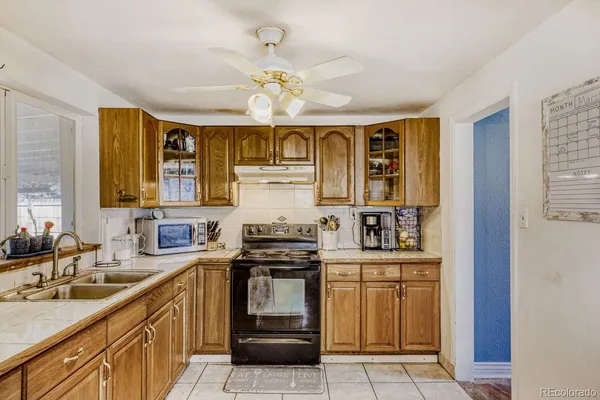 a kitchen with a sink stove and cabinets