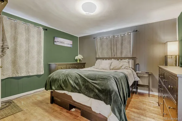 a bedroom with a bed and a mirror