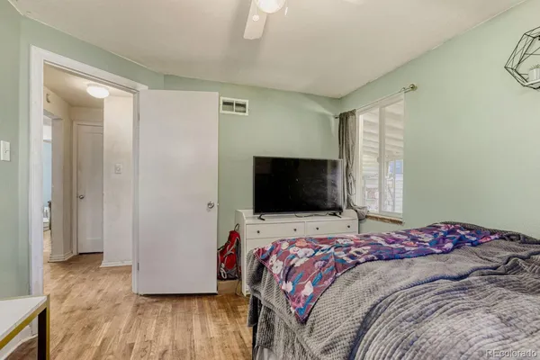 a bedroom with a bed and a flat screen tv